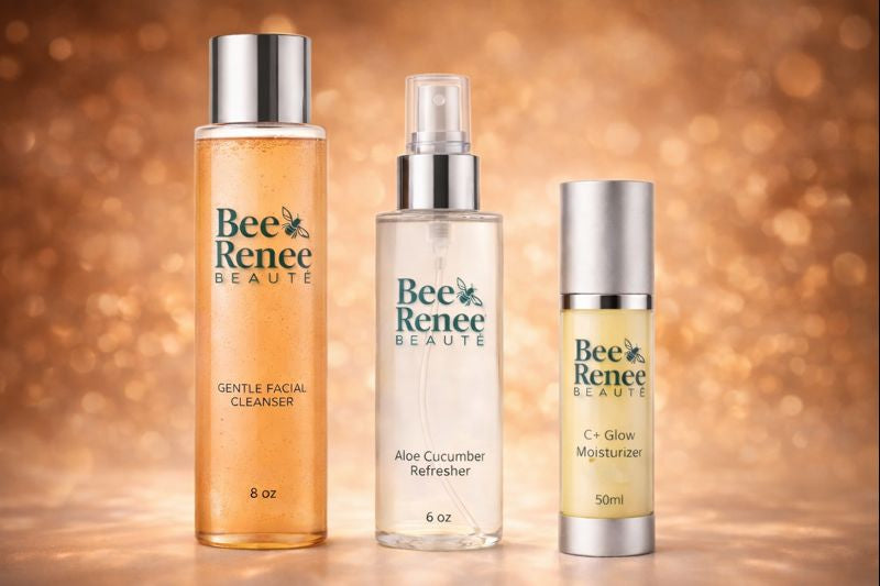 Three bottles of Bee Renee Beauté skincare products on a warm, blurred background.