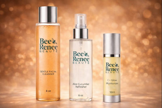 Three bottles of Bee Renee Beauté skincare products on a warm, blurred background.